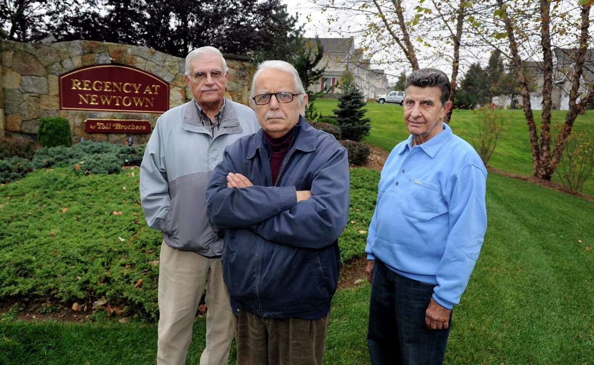 Louis Carbone, 80, left; Rudy Magnan, 72, center; and Rocco Miano, 75, meet at the entrance to Regency at Newtown, where Magnan lives. Carbone and Miano live in a similar community, Liberty at Newtown. The men are part of a group of seniors demanding tax relief.