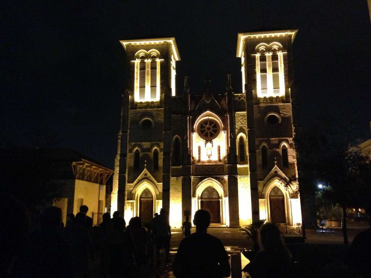 Ghost tour enthusiasts take photos of San Fernando Cathedral.