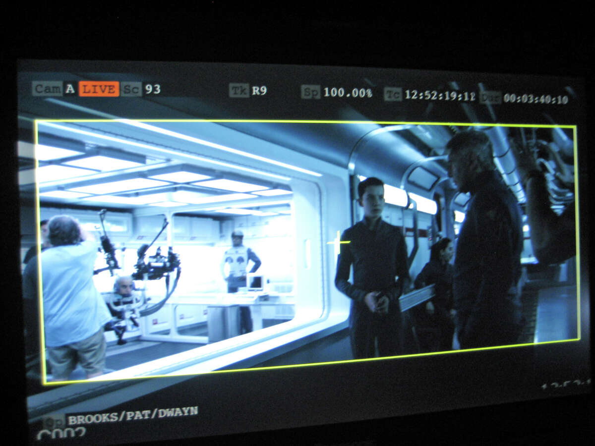 At right, actors Asa Butterfield and Harrison Ford during the filming of a scene from “Ender’s Game.” The UW robot can be seen on the left.