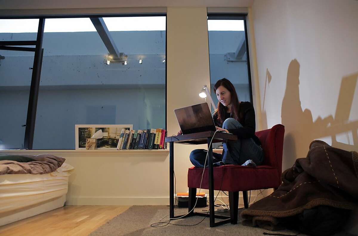 Kayla Smith orders groceries on her laptop in her San Francisco, Calif., apartment on Tuesday, October 29, 2013. Smith moved into the micro apartment about two months ago, when she was hired by Webpass, a San Francisco-based internet company. The tiny space, about 280 square feet is perfect for her lifestyle at the moment, she says, but she still needs to furnish the apartment so it feels less sparse.