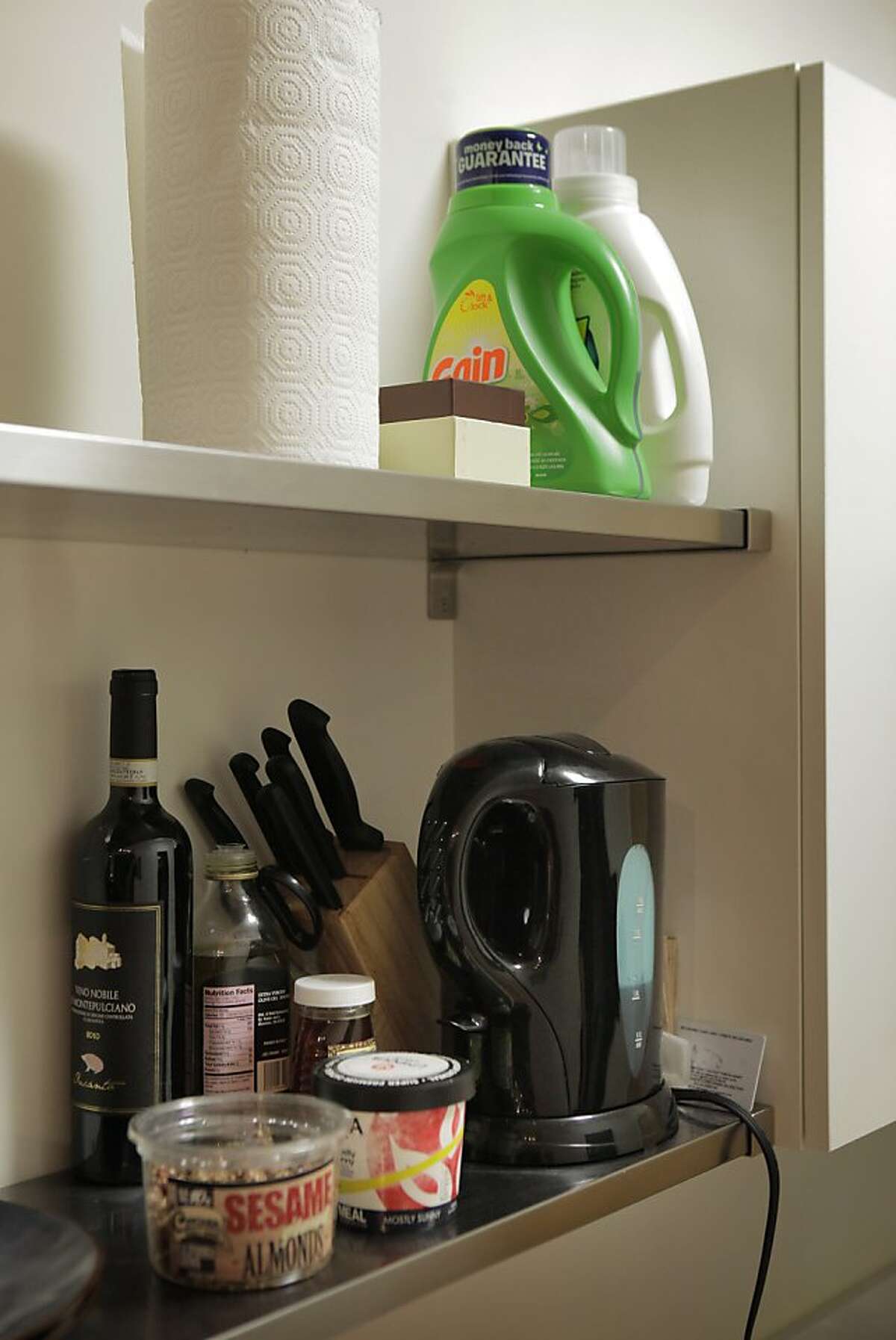 Having limited storage space, Kayla Smith stores her laundry supplies in the shelves of her kitchen along with her coffee maker in her San Francisco, Calif., apartment on Tuesday, October 29, 2013. Smith moved into the micro apartment about two months ago, when she was hired by Webpass, a San Francisco-based internet company. The tiny space, about 280 square feet is perfect for her lifestyle at the moment, she says, but she still needs to furnish the apartment so it feels less sparse.