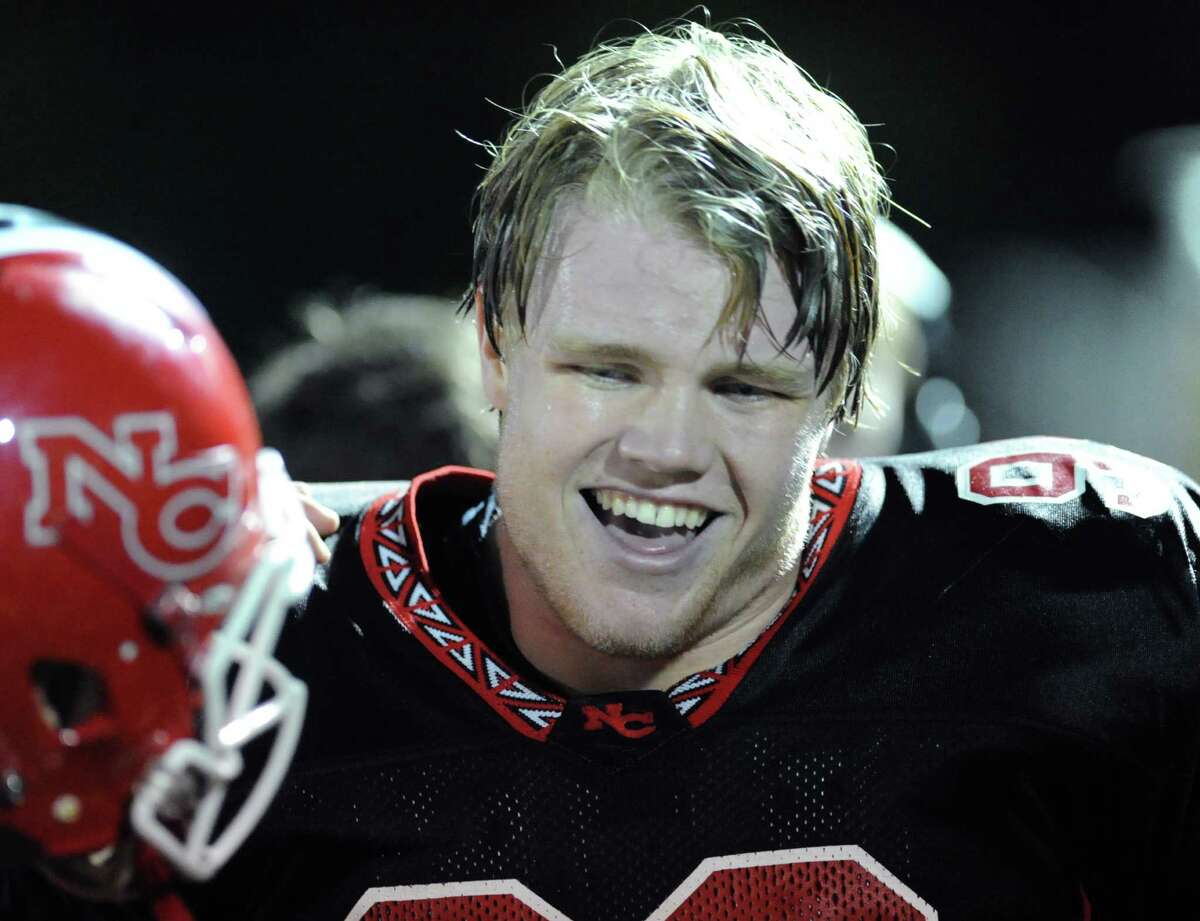 Connor Buck of New Canaan smiles after running back a fumble recovery 56 yards for a touchdown during the second quarter of the high school football game between New Canaan and St. Joseph at New Canaan, Friday night, Nov. 1, 2013.