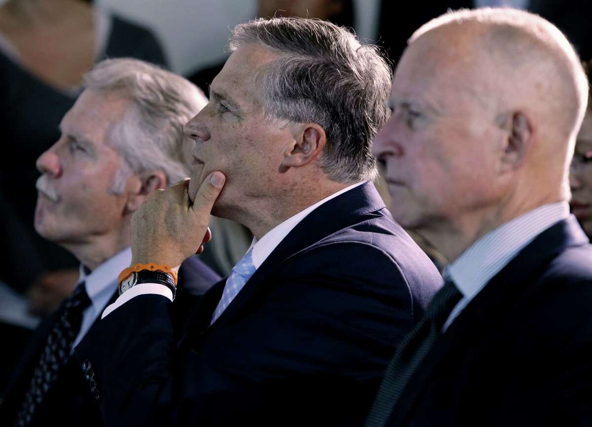 Oregon Gov. John Kitzhaber, Washington Gov. Jay Inslee and California Gov. Jerry Brown listen to a speaker Monday in San Francisco before signing an agreement to combat climate change. Inslee and Brown are two of the eight governors on President Barack Obama's new task force.