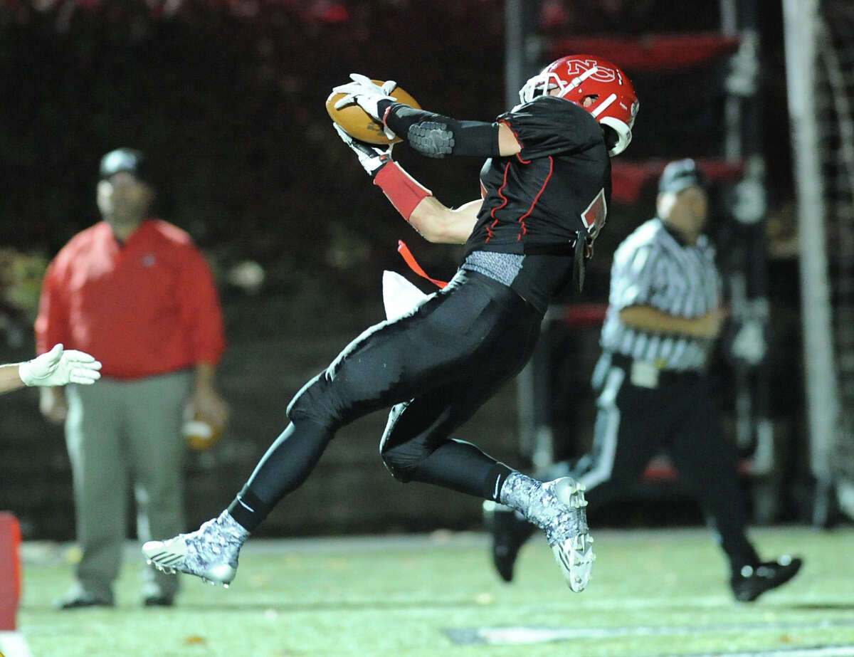 Wide receiver Alex LaPolice of New Canaan makes a catch for a first quarter touchdown during the High School football game between New Canaan High School and St. Joseph High School at New Canaan, Friday, Nov. 1, 2013.