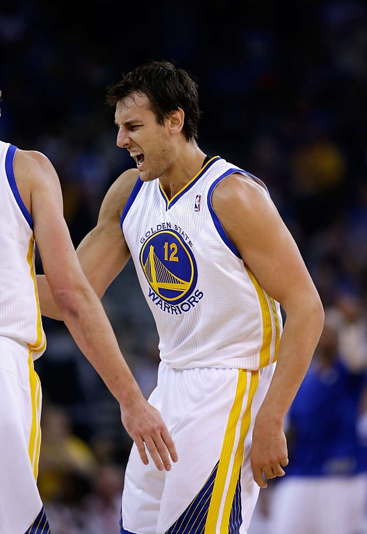 Andrew Bogut #12 of the Golden State Warriors reacts after the Warriors made a basket against the Los Angeles Lakers at ORACLE Arena on October 30, 2013 in Oakland, California.