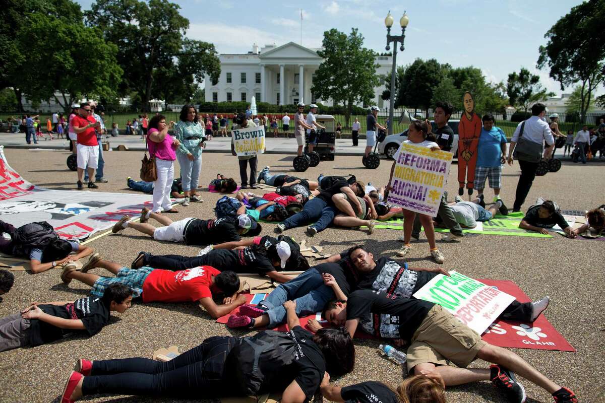 Protesters lay down in front of the White House during a demonstration to signify family members deported, as they rallied in favor of immigration reform.
