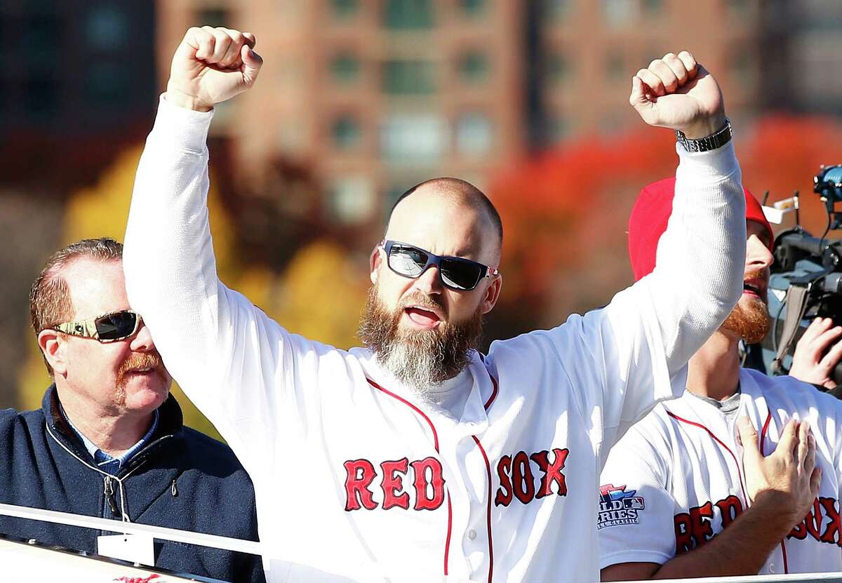 BOSTON, MA - NOVEMBER 02: David Ross #3 and Will Middlebrooks #16 of the Boston Red Sox celebrate on the Charles River during the World Series victory parade on November 2, 2013 in Boston, Massachusetts.