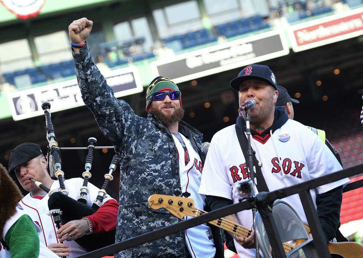 BOSTON, MA - NOVEMBER 2: Jonny Gomes (L) and Ken Casey of the Drop Kick Murphys perform for the crowd before the Red Sox players board the duck boats for the World Series victory parade for the Boston Red Sox on November 2, 2013 in Boston, Massachusetts.