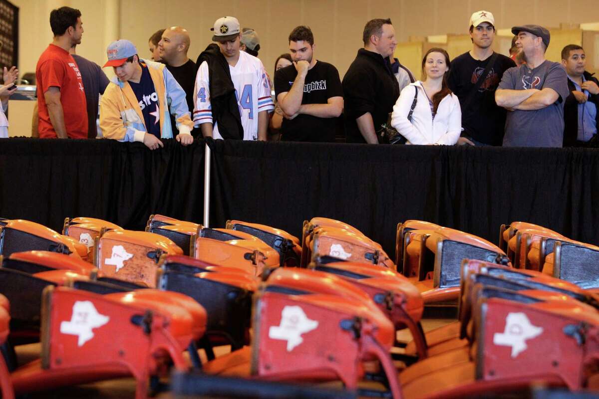 People wait in line at Reliant Center to buy seats during the auction and sale of Astrodome items Saturday in Houston.