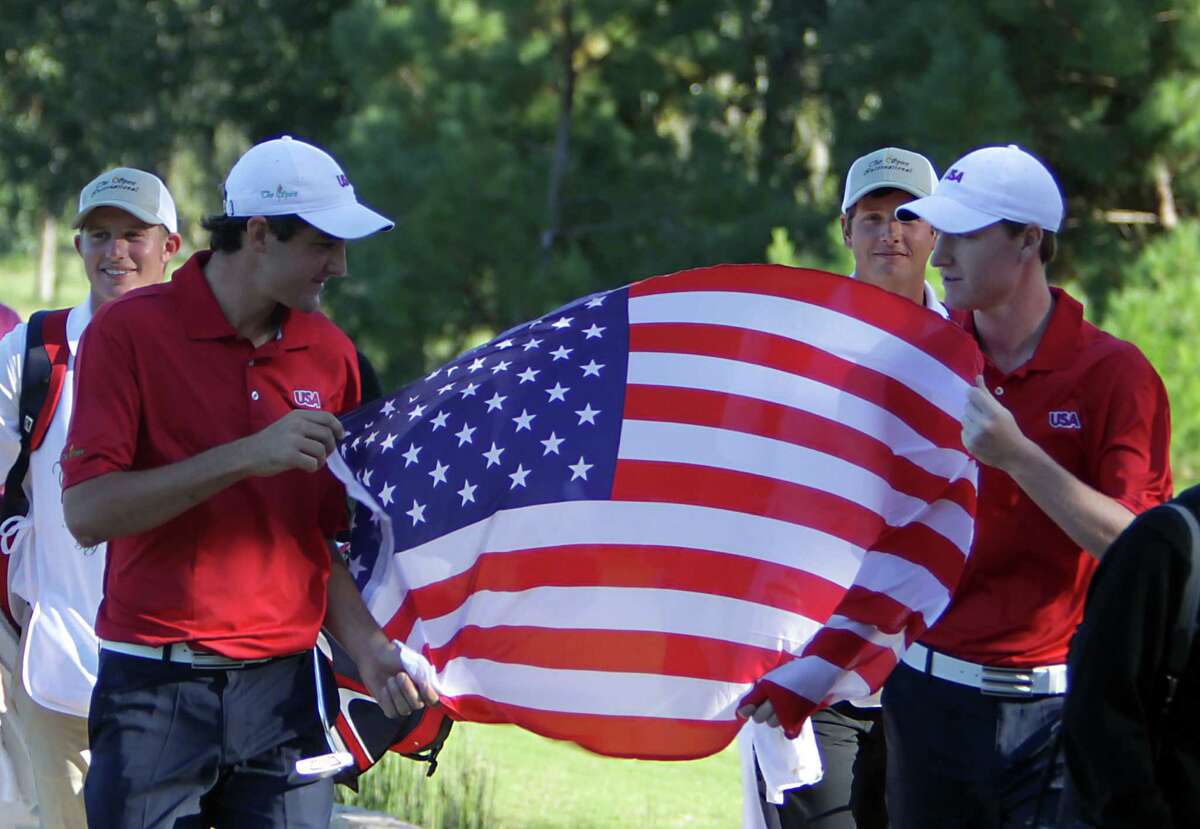 Scott Scheffler left, and Jordan Niebrugge hoist the U.S. flag after their final-round 8-under 64 clinched the international team and men's team titles.
