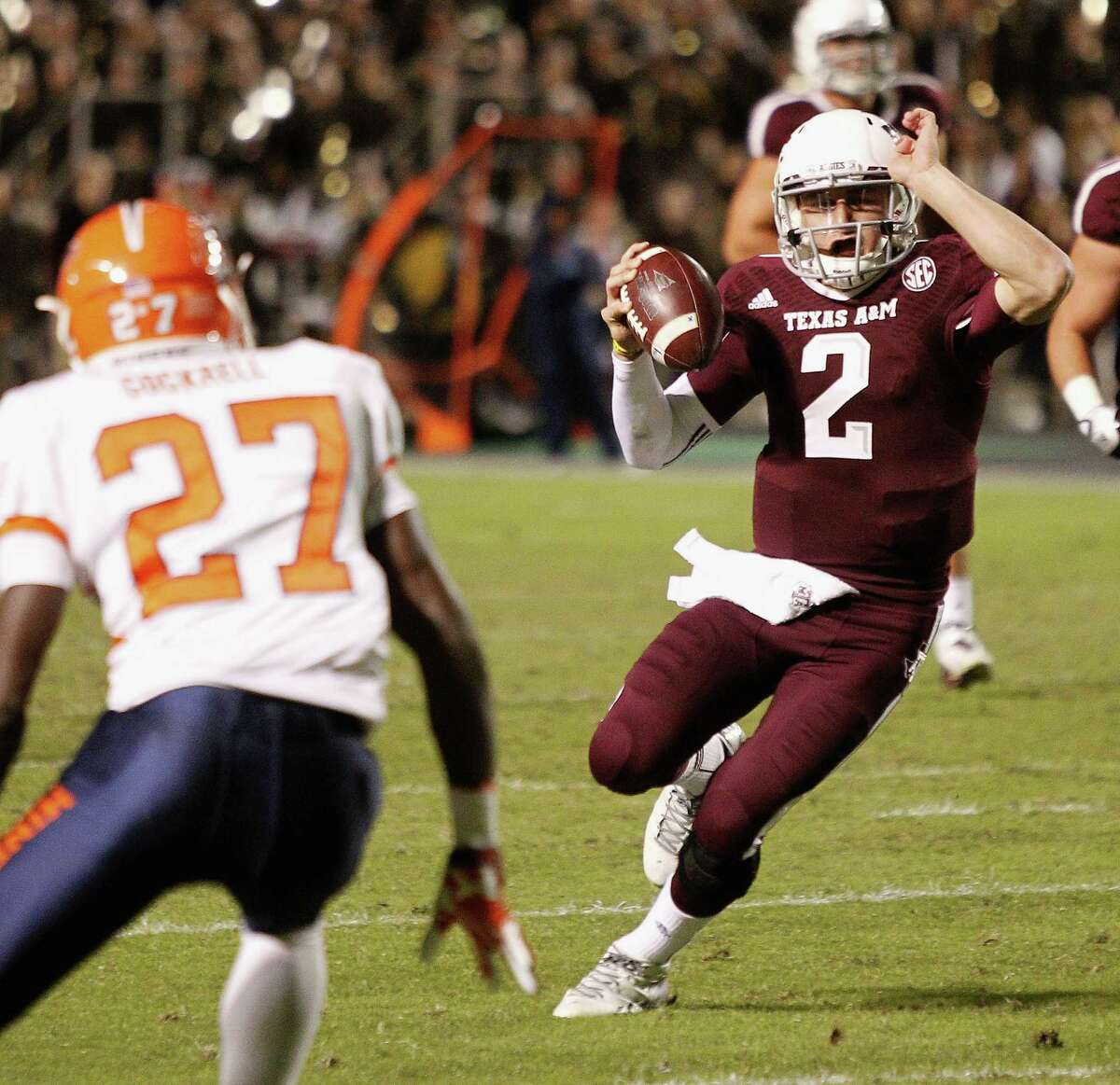 COLLEGE STATION, TX - NOVEMBER 02: Johnny Manziel #2 of the Texas A&M Aggies runs with the ball in the second quarter as defensive back Devin Cockrell #27 of the UTEP Miners looks to make a tackle at Kyle Field on November 2, 2013 in College Station, Texas.