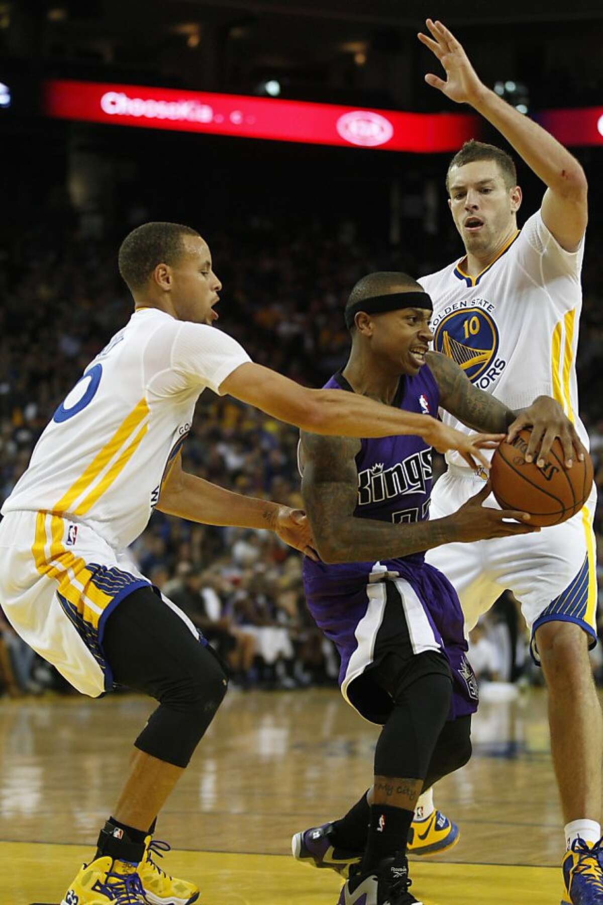 Warriors' Stephen Curry, left, and David Lee surround Kings' Isaiah Thomas November 2, 2013 during the Warriors vs. Kings game at the Oracle Arena in Oakland, Calif.