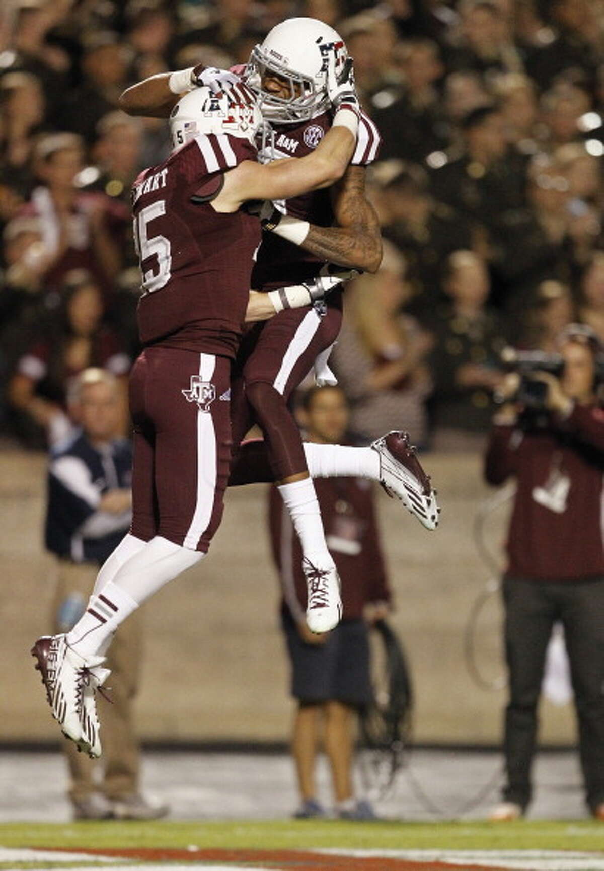 Travis Labhart #15 of the Texas A&M Aggies celebrates with Mike Evans #13 after scoring in the first quarter against the UTEP Miners at Kyle Field on November 2, 2013 in College Station, Texas.