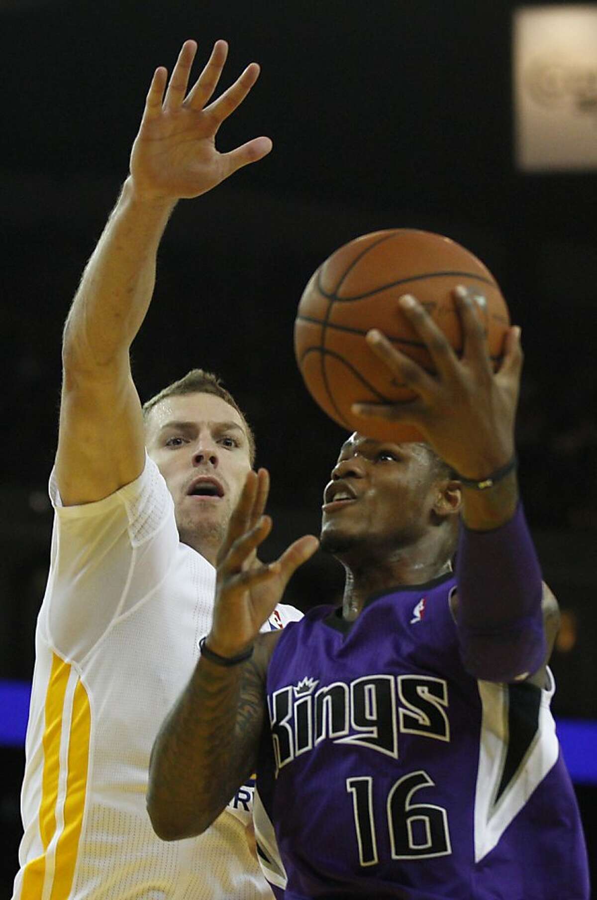 Warriors' David Lee, left, puts a block on Kings' Ben Mclemore November 2, 2013 during the Warriors vs. Kings game at the Oracle Arena in Oakland, Calif.