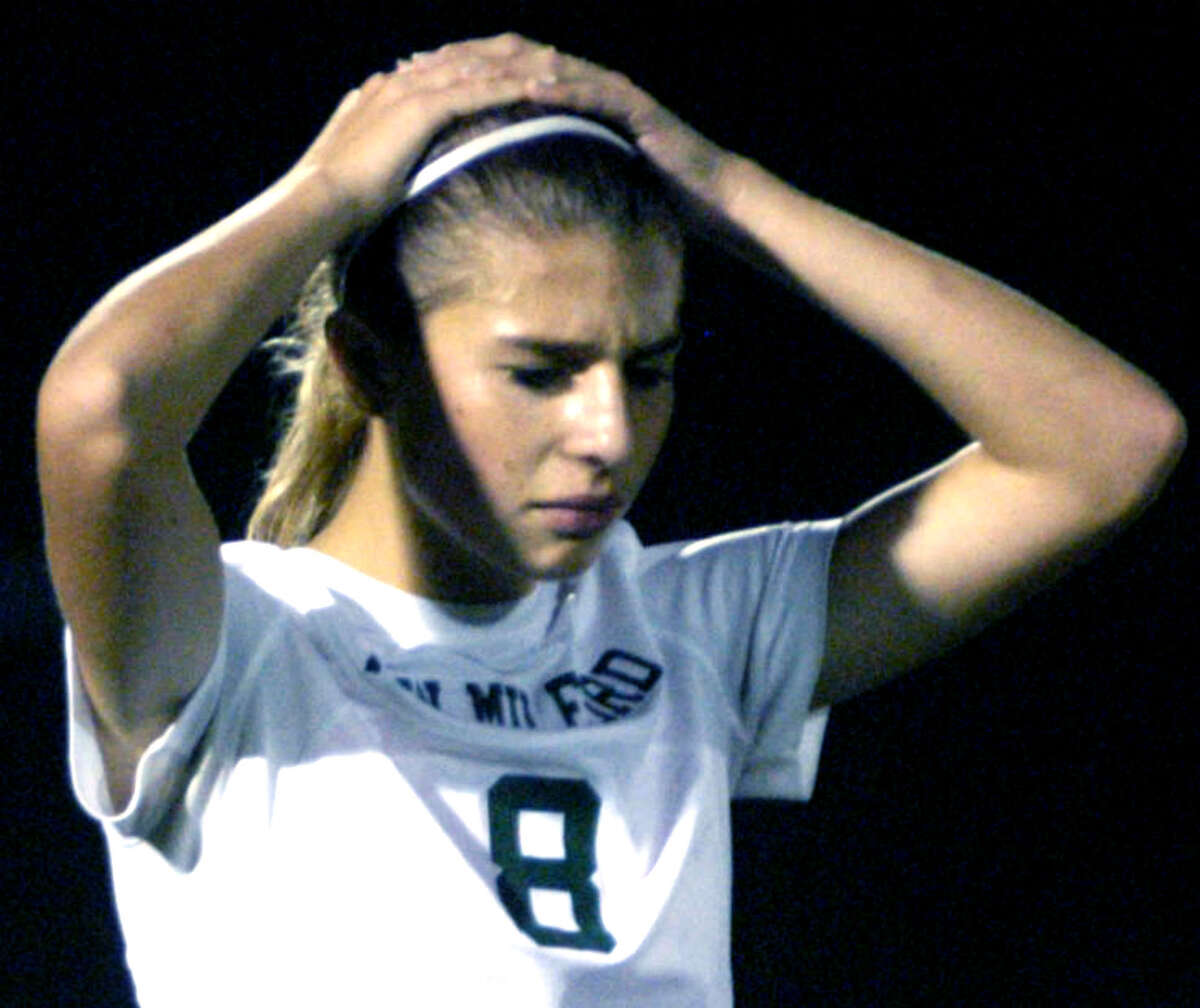 The Green Wave's Saige Grazia is in disbelief seconds after New Milford High School girls' soccer had lost a 2-1 double-overtime decision to Pomperaug in the South-West Conference final at Newtown High. Nov. 1, 2013 afte