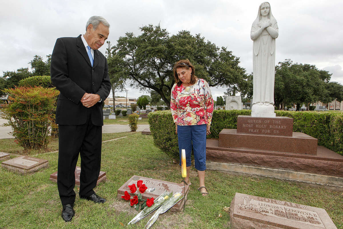 Former Congressman Charlie Gonzalez, left, and his sister, Genevieve Barto, visit the grave of their father, former Congressman Henry B. Gonzalez at San Fernando Cemetery No. 2 on Día de los Muertos last Wednesday.