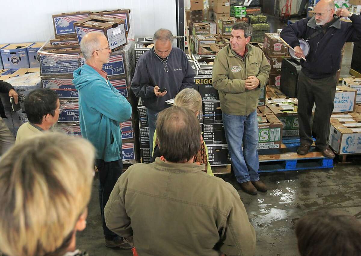 Jack Pizza, Owner of Washington Vegetable Company, second from right, takes questions from a group of farmers October 29, 2013 during a tour and discussion about wholesale food selling techniques and requirements at Washington Vegetable Company in San Francisco, Calif. Small farmers who typically only sell at farmer's markets are learning through a UC Davis Extension about how to become wholesalers.