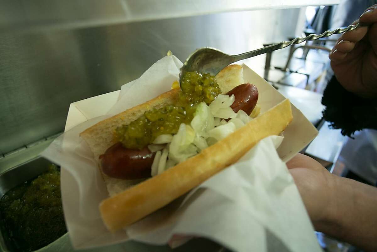 A "Top Dog" being dressed with relish at Top Dog in Berkeley, Calif. on Wednesday, October 23rd, 2013.