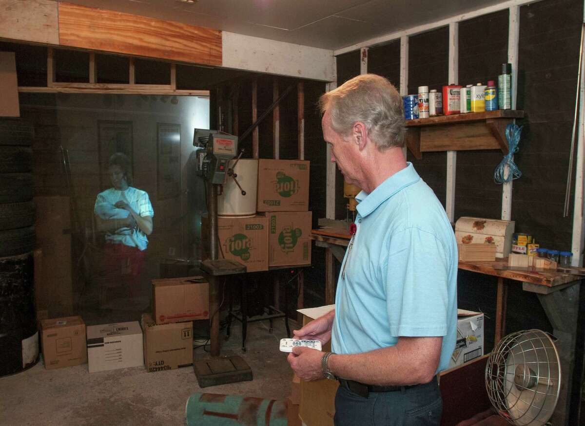 In this Oct. 29, 2013 photo, Kevin Kendro, archive coordinator for the city of Irving, Texas, demonstrates a projection technique called Pepper's Ghost in the garage of the Ruth Paine House Museum, in Irving. The museum in the small, two-bedroom home that once belonged to Ruth Paine, who had befriended Lee Harvey Oswaldâs wife Marina and let her live there with her two daughters, will open Wednesday, Nov. 4, 2013. The garage is where Lee Harvey Oswald stored his rifle. (AP Photo/Rex C. Curry)