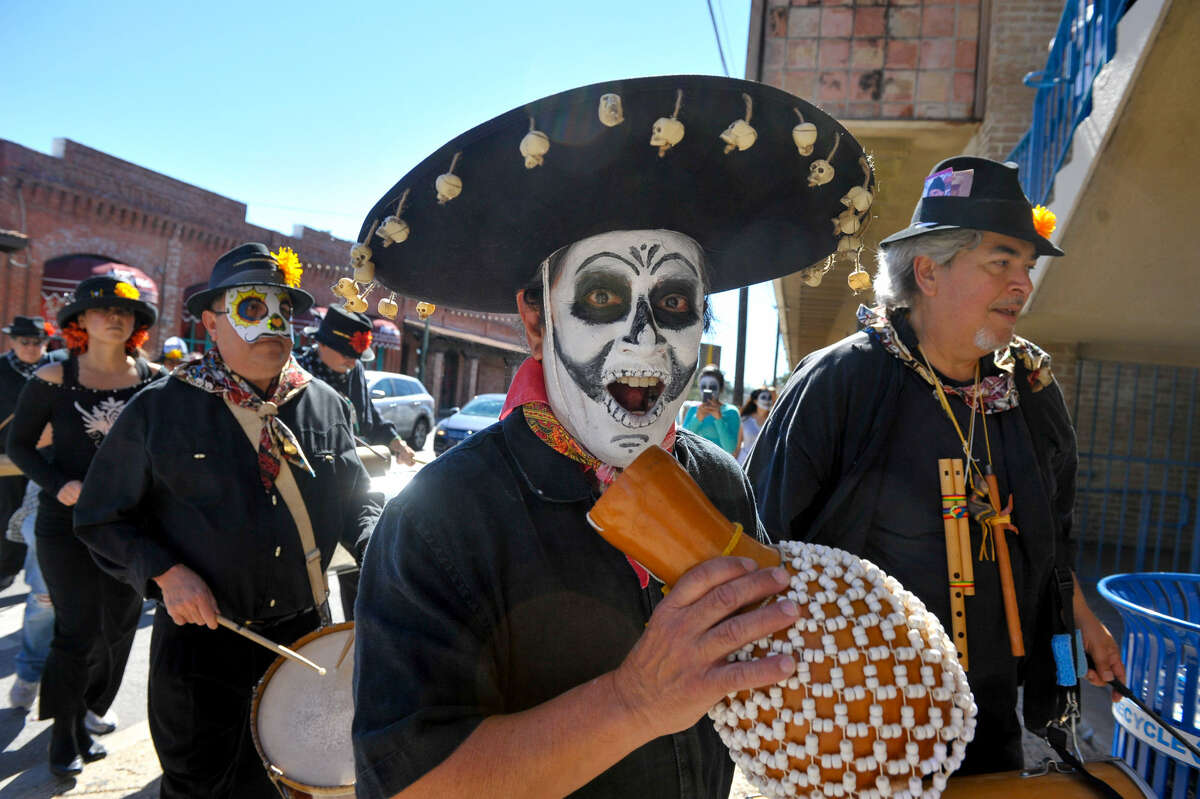 Members of Los Olvidados march through Market Square during Día de los Muertos festivities last weekend. The colorful events honoring the dearly departed occurred throughout much of the South Side and West Side.