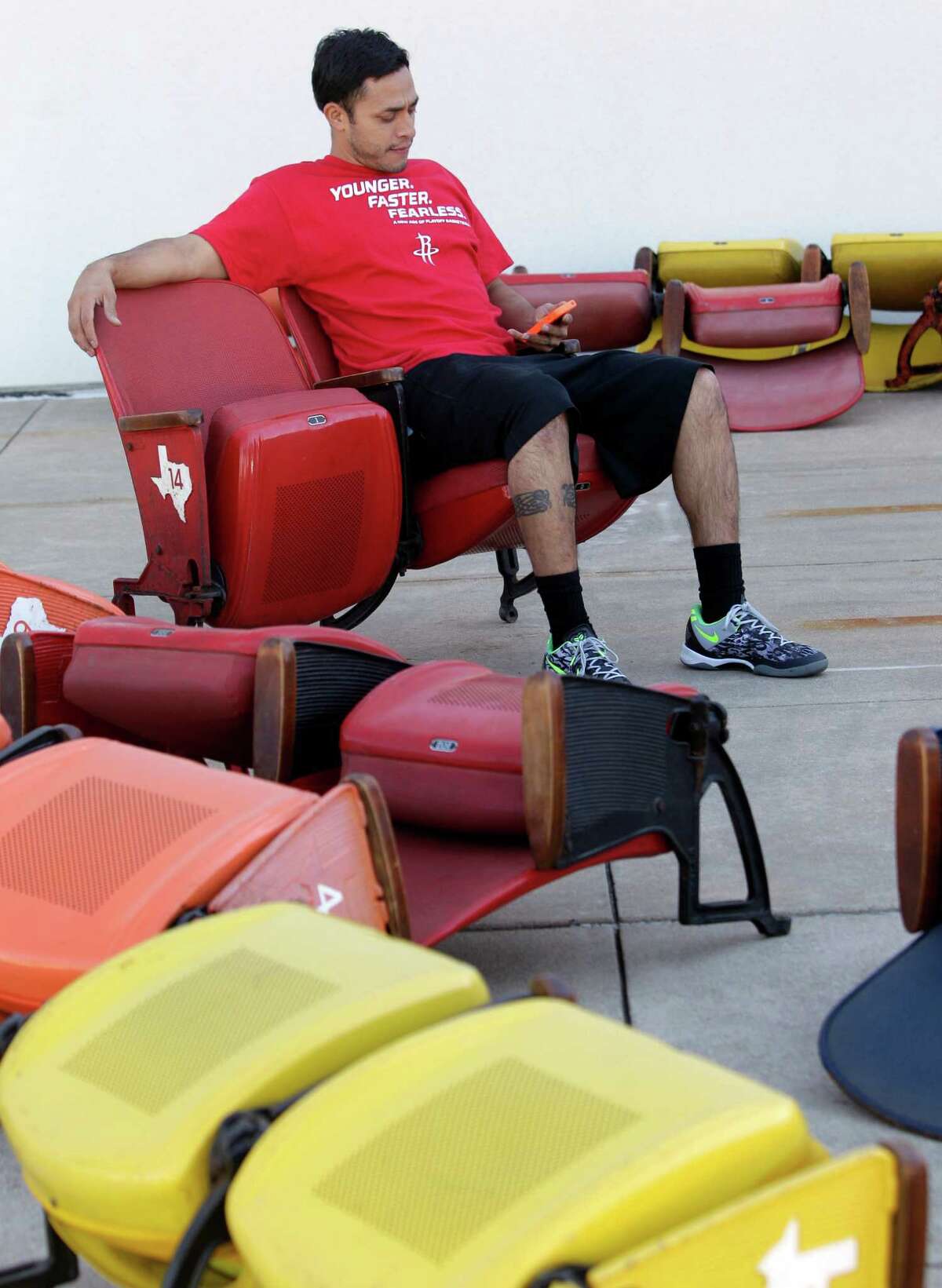 Steve Arce sits in an Astrodome seats as he waits outside Reliant Center to load the seats Saturday, Nov. 2, 2013, in Houston. ( Melissa Phillip / Houston Chronicle )