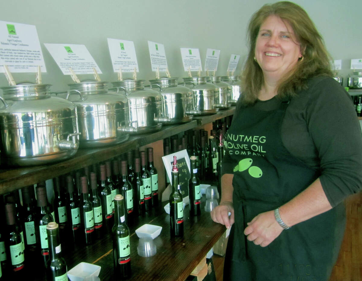 Maureen Kenny offers a welcoming smile to patrons of her Nutmeg Olive Oil Company shop along Main Street in New Milford. November 2013
