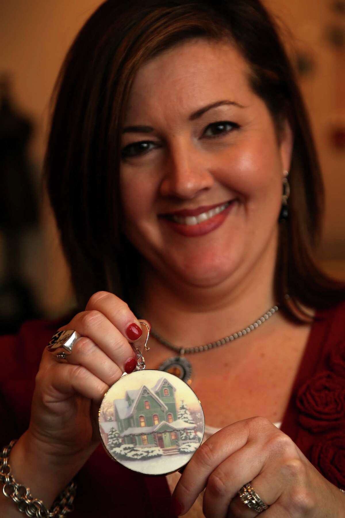 Christie Gunter, of China Baroque, who makes jewelry and other items such as this Christmas ornament, out of china pieces, Monday, Oct. 28, 2013, in Houston. She and her design team use old china pieces to make the custom jewelry collection and they will be showing at the upcoming Nutcracker Market. ( Karen Warren / Houston Chronicle )