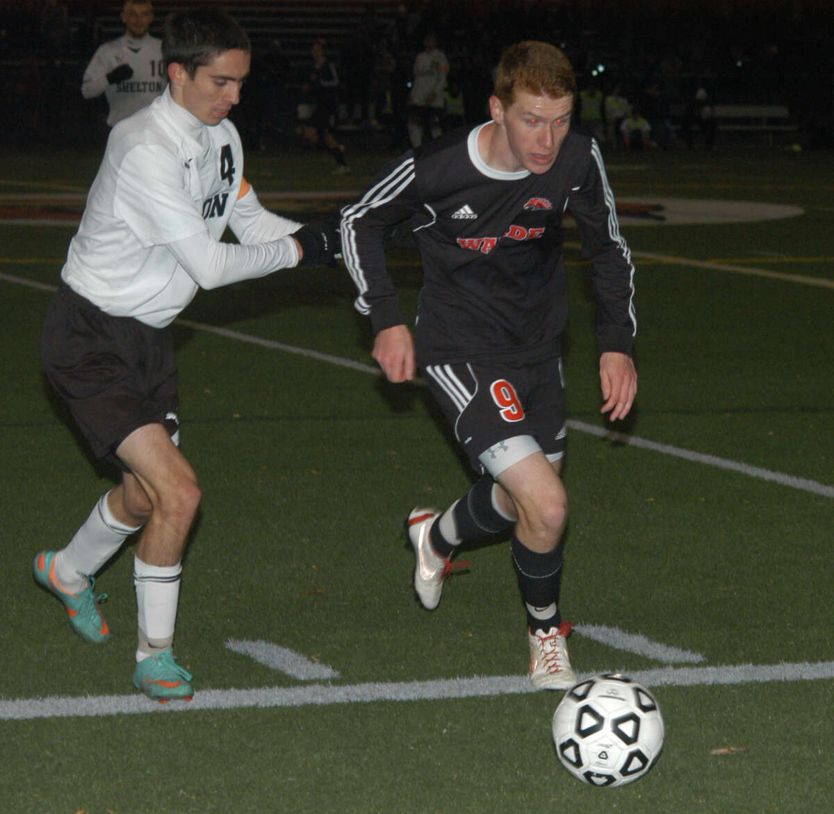 Shelton's John Hunter (4) chases Fairfield Warde's Peter Stymacks (9) on Tuesday, Nov. 5 in the Mustangs' 1-0 win at Shelton in a CIAC Class LL boys soccer state tournament first-round match.
