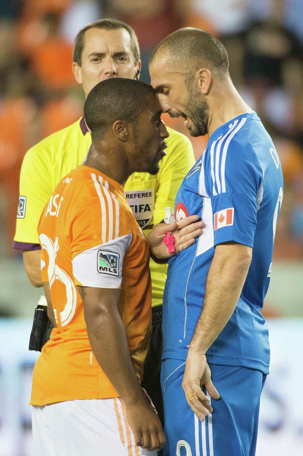 "He's a bit chippy," says Dynamo teammate Bobby Boswell of midfielder Corey Ashe, left, and it's safe say to that Montreal forward Marco Di Vaio, right, would agree.