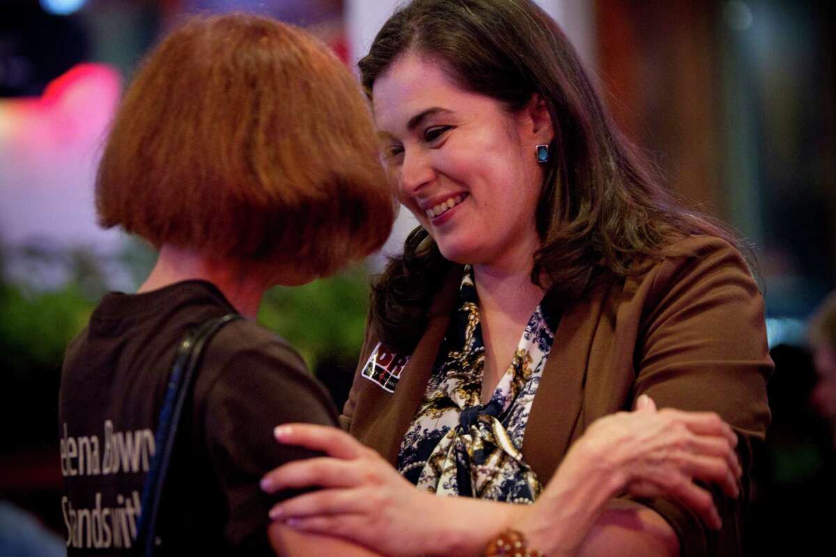 District A representative Helena Brown embraces supporter Mary Louise Charrin. Brown will face Brenda Stardig in a runoff.