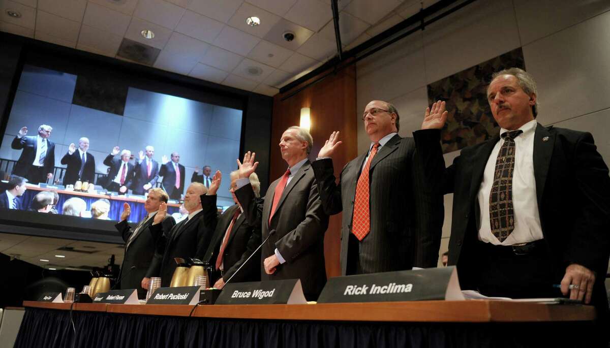 The first panel of witnesses are sworn in prior to testifying before the National Transportation Safety Board (NTSB) investigative hearing in Washington, Wednesday, Nov. 6, 2013.on two recent Metro-North Railroad accidents that occurred in Connecticut. From left are, Gary Carr with the Federal Railroad Administration, Kenneth Rusk with the Federal Railroad Administration, Robert Florom with the Transportation Technology Center, Inc., Robert Puciloski with Metro-North Railroad, Bruce Wigod, with New Jersey Transit, and Rick Inclima with the Brotherhood of Maintenance of Way Employees.