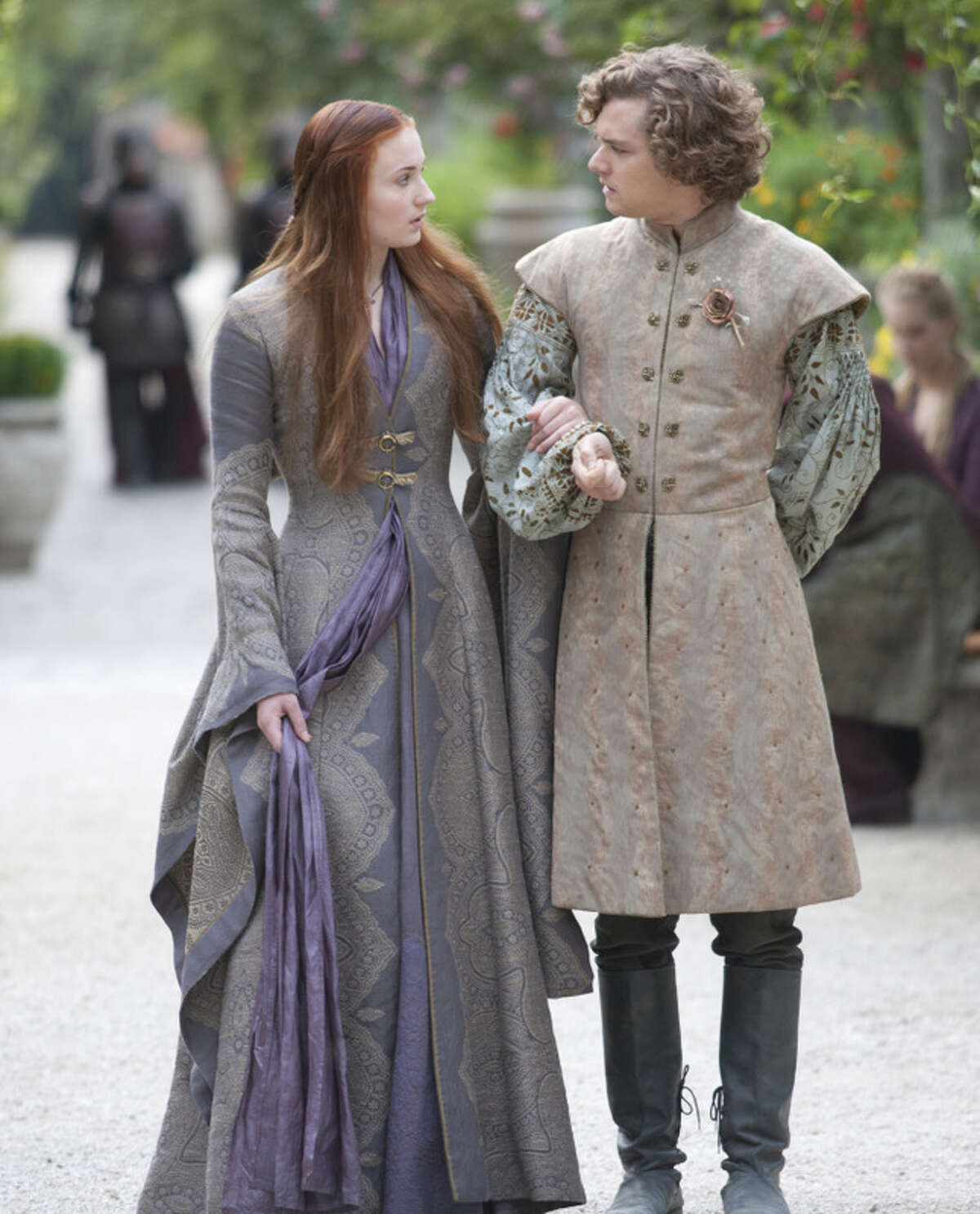 Sophie Turner as Sansa Stark and Finn Jones as Loras Tyrell walk together during shooting of "Game of Thrones." >>Keep clicking to see ten things we learned during last year's Comicpalooza.