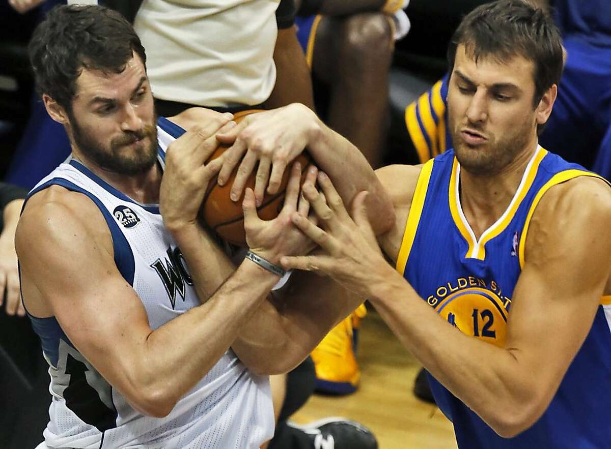 Kevin Love of the Minnesota Timberwolves and Andrew Bogut (12) of the Golden State Warriors fight for control of the ball at the Target Center in Minneapolis on Wednesday, Nov. 6, 2013. The Warriors won, 106-93. (Marlin Levison/Minneapolis Star Tribune/MCT)