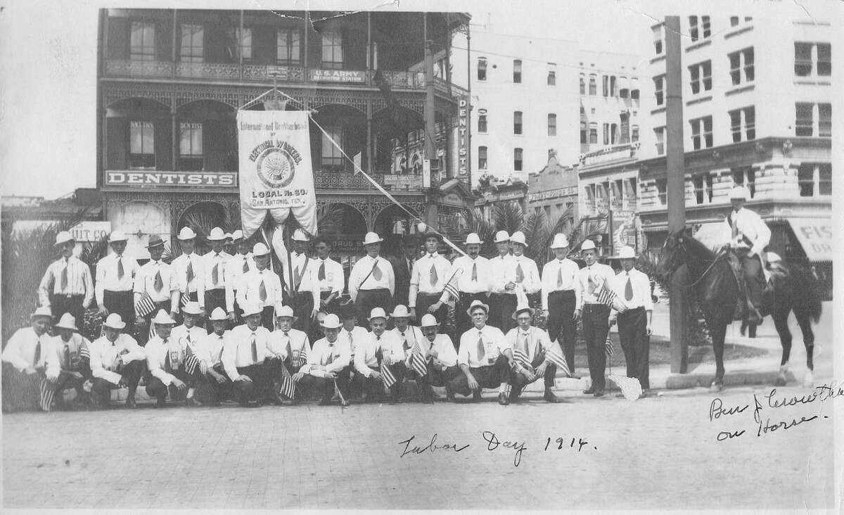 This photograph was taken for the Labor Day parade of 1914. Behind the electrical workers on Alamo Plaza is the Maverick Bank Building.