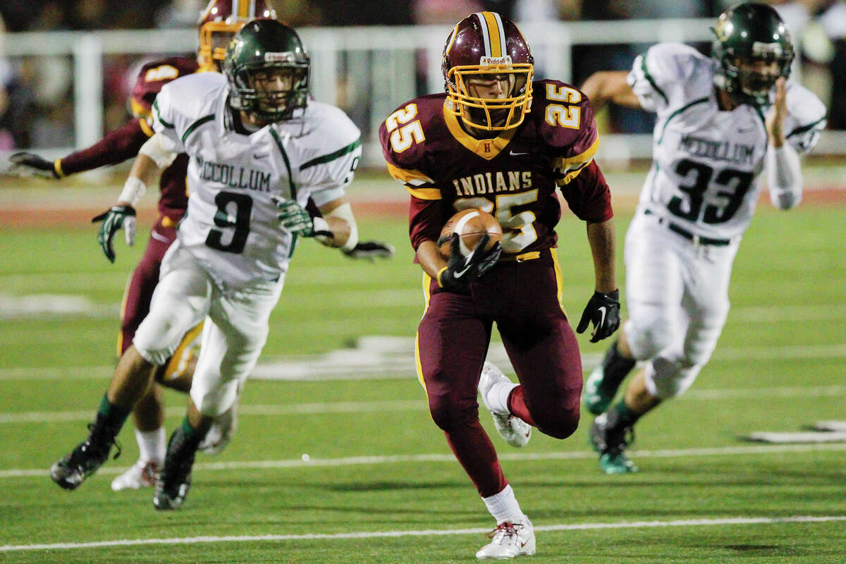 Harlandale's John Aguirre (25) breaks free into the Cowboy secondary as McCollum's Chris Herrera (left) and John Martinez give chase during the second half of the 50th annual Frontier Bowl between Harlandale and McCollum at Harlandale Memorial Stadium on Friday, Nov. 8, 2013. Harlandale beat the Coyboys 27-17. MARVIN PFEIFFER/ mpfeiffer@express-news.net