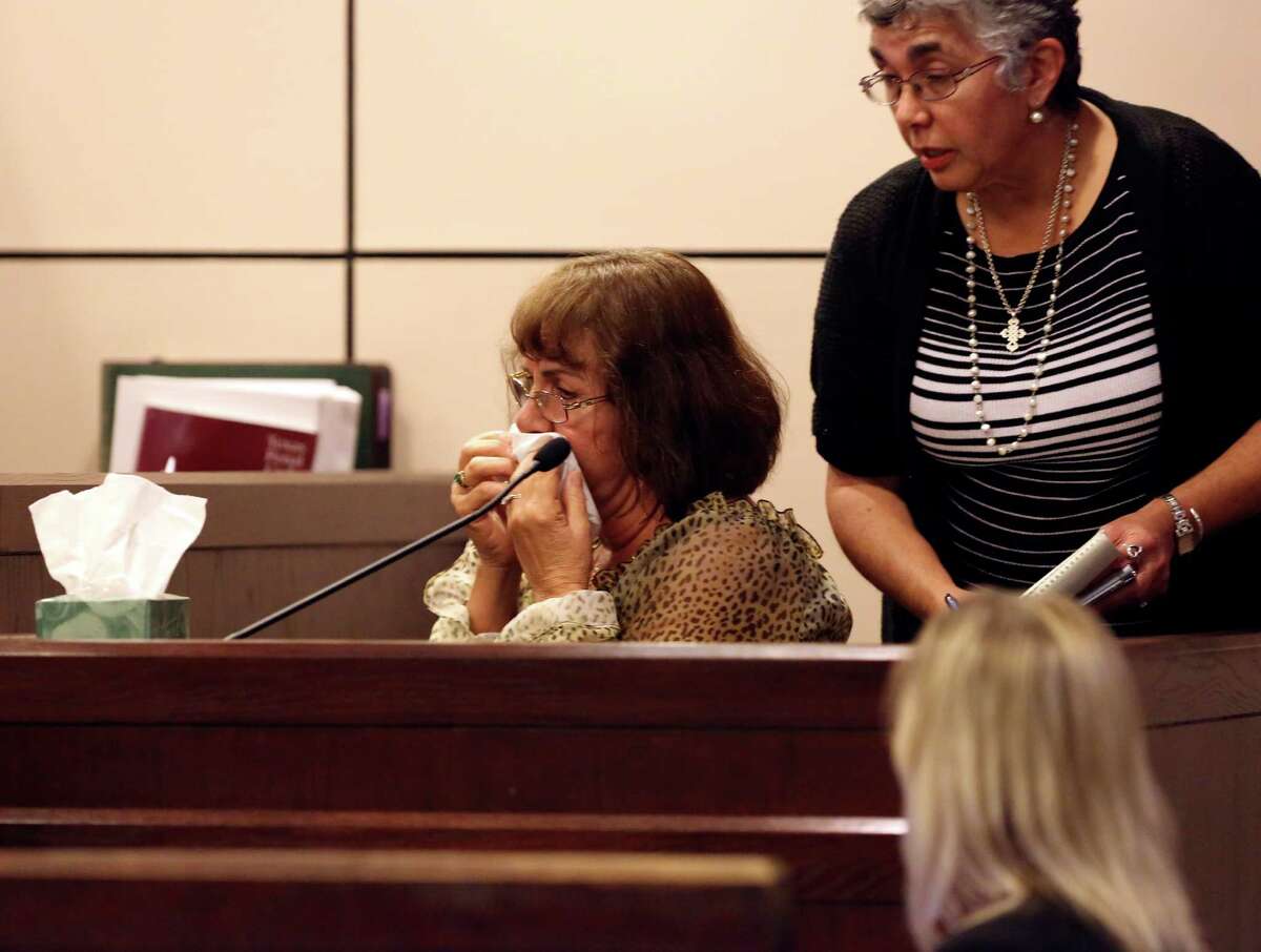 Maria Hollis cries as she testifies in Norberto Velasquez's trial on Tuesday Nov. 5, 2013. Velasquez faces a first-degree felony injury to a child. He and partner Matthew Aranda adopted a 3-year-old foster child who died of head trauma less than a month later while in their care. Aranda is still awaiting trial on murder.