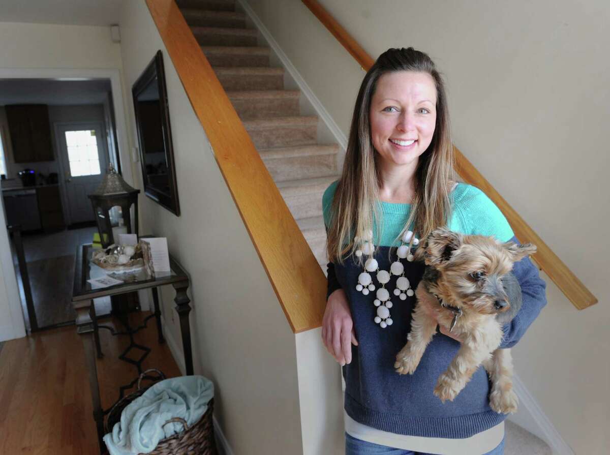 Krista Way with her Yorkshire terrier, Toby, in her Greenwich home, Saturday, Nov. 9, 2013. Way, who is single, lives in the Chickahominy section of Greenwich in a duplex.