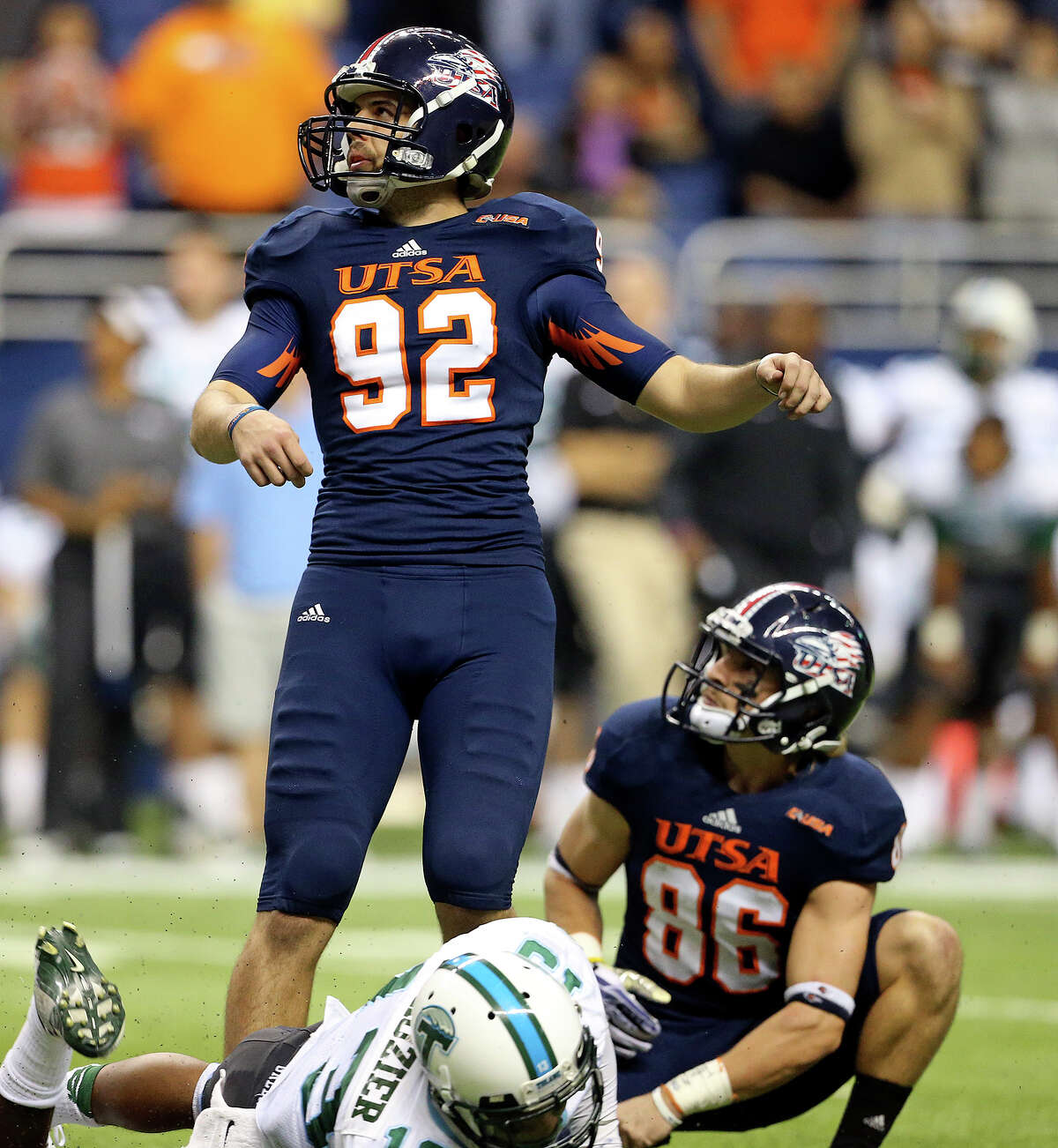 Sean Ianno watches his kick go through the uprights to prove the winning score as holder Seth Grubb holds as UTSA hosts Tulane at the Alamodome on November 10, 2013.