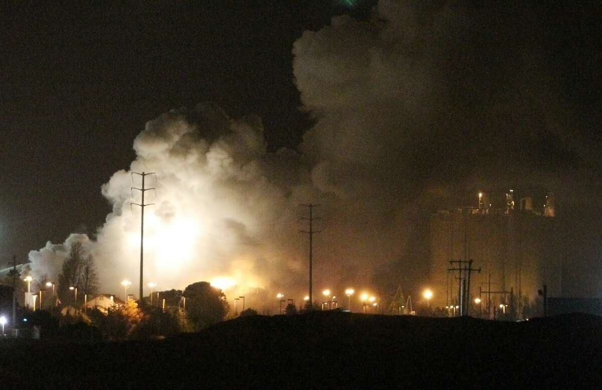 Smoke rises from a fire at a metal recycling facility (not pictured) in Redwood city, Calif. on Sunday, Nov. 10, 2013.