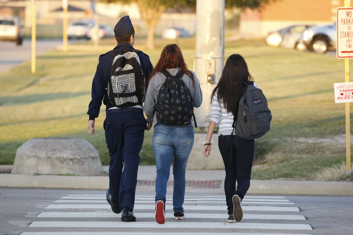 Students head to school at Cy-Springs High School Monday morning.