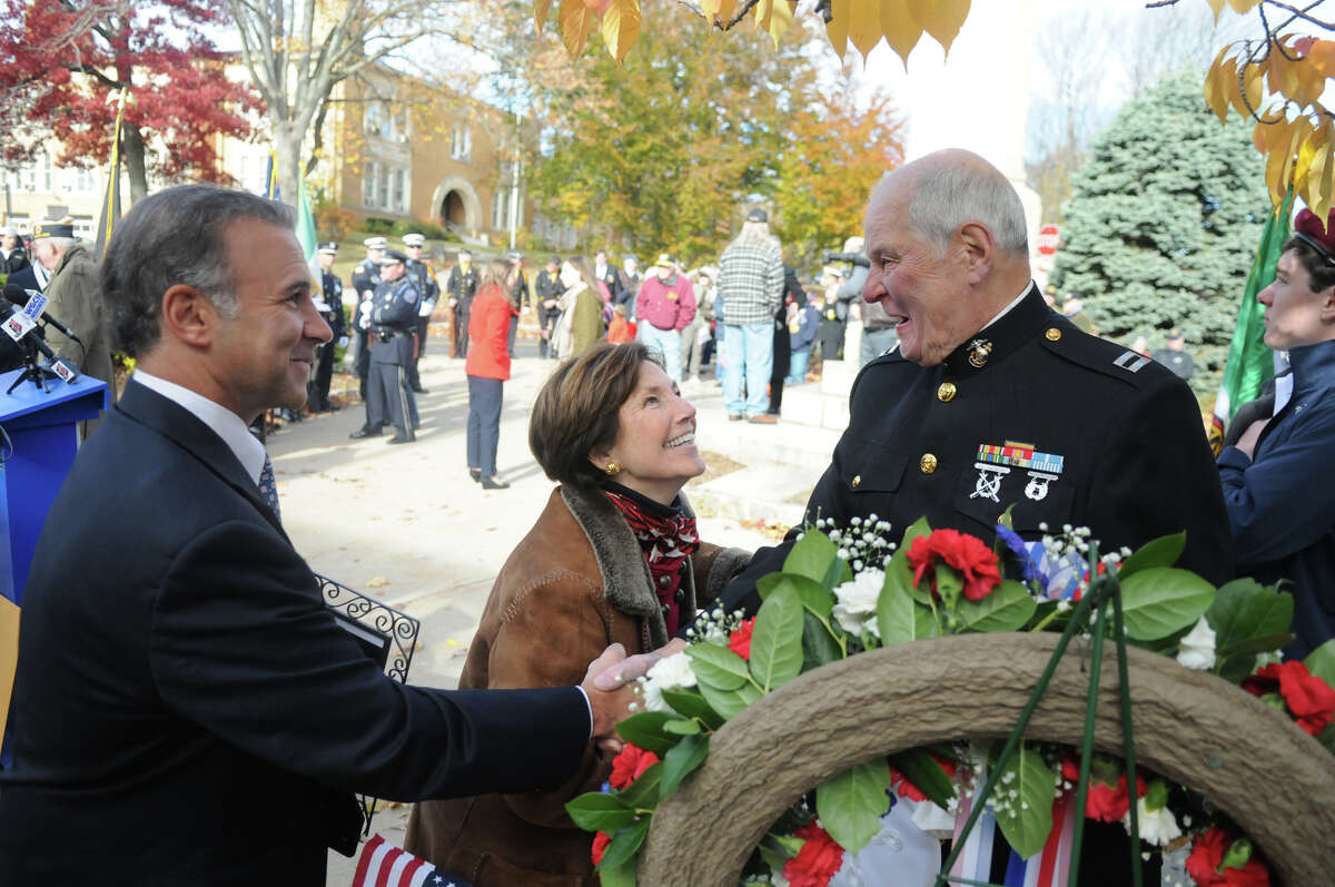 Representatives Fred Camillo and Livvy Floren chat with Korean War Marine Corps Veteran Jim Larkin as the Greenwich American Legion hosts a Veteran's Day ceremony at the war monument on Greenwich Avenue in Greenwich, Conn., Nov. 11, 2013.