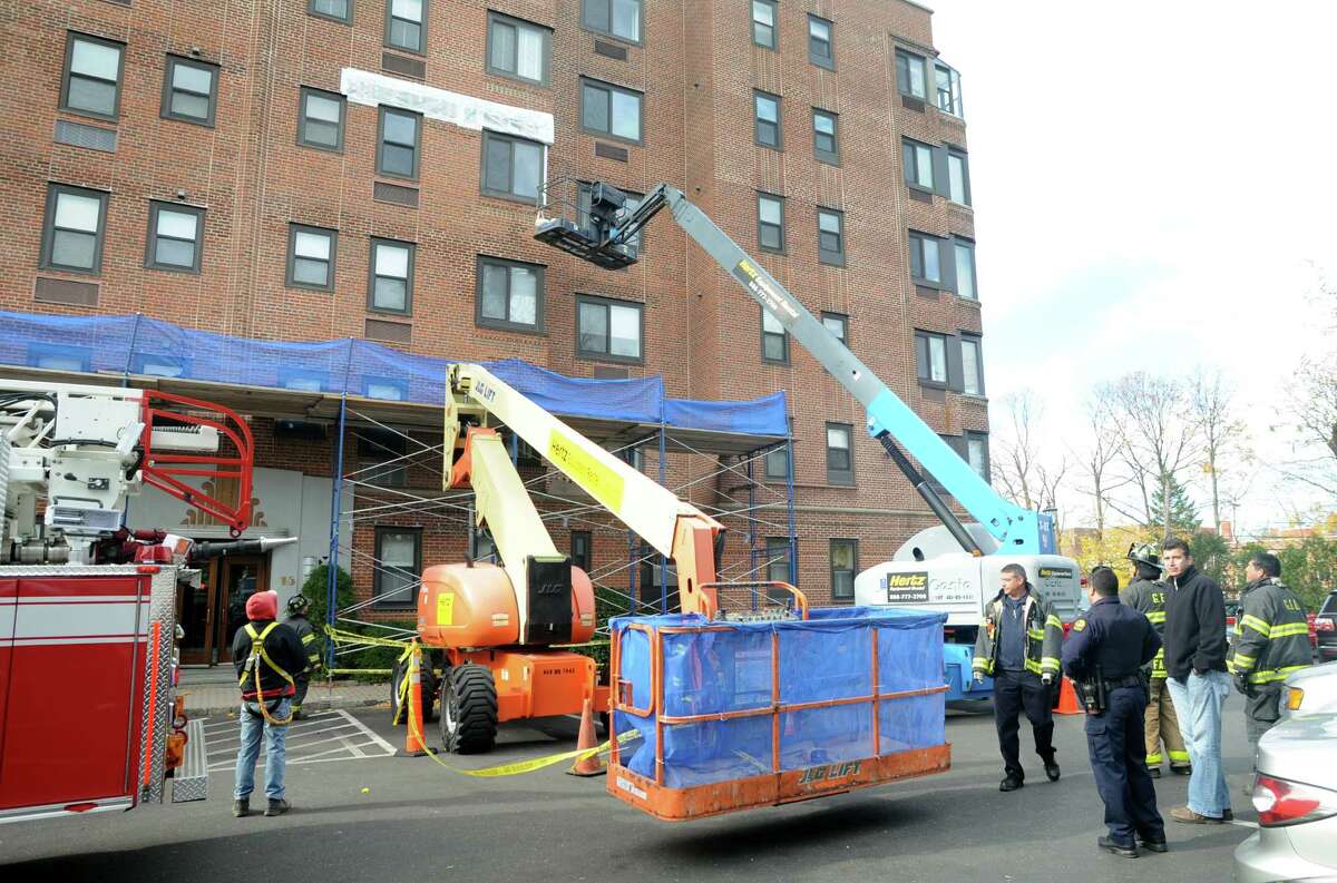 Three construction workers were stranded following a lift malfunction at an apartment building at 15 Lafayette Court in Greenwich, Conn. on Monday, Nov. 11, 2013. Greenwich Fire, Police, and Emergency Medical Services units were dispatched to the scene where the men working on the brick facade became stuck some 30 feet in the air. Firefighters rescued the men using an aerial ladder. No one was hurt in the incident.