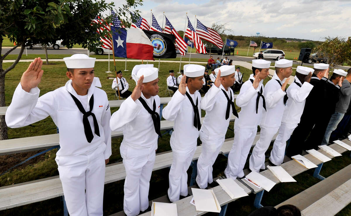 Sailors take the Immigration and Naturalization Oath to become U.S. citizens Sunday during the Veterans Day ceremony at Fort Sam Houston National Cemetery. 