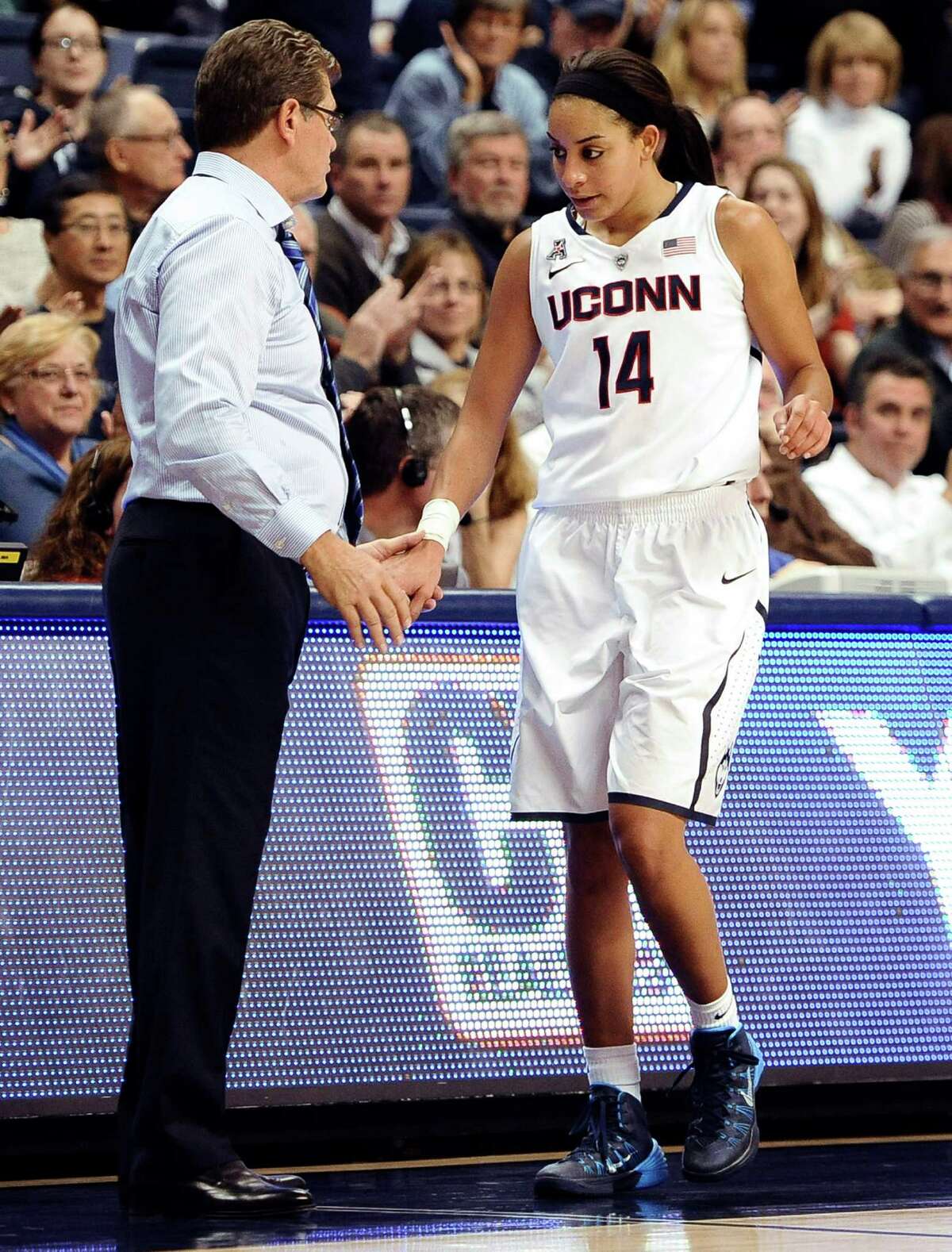 Connecticut's Bria Hartley, right, is greeted by Connecticut head coach Geno Auriemma during the second half of an NCAA college basketball game, Monday, Nov. 11, 2013, in Storrs, Conn. Hartley was top scorer for Connecticut with 20 points. Connecticut won 76-57.