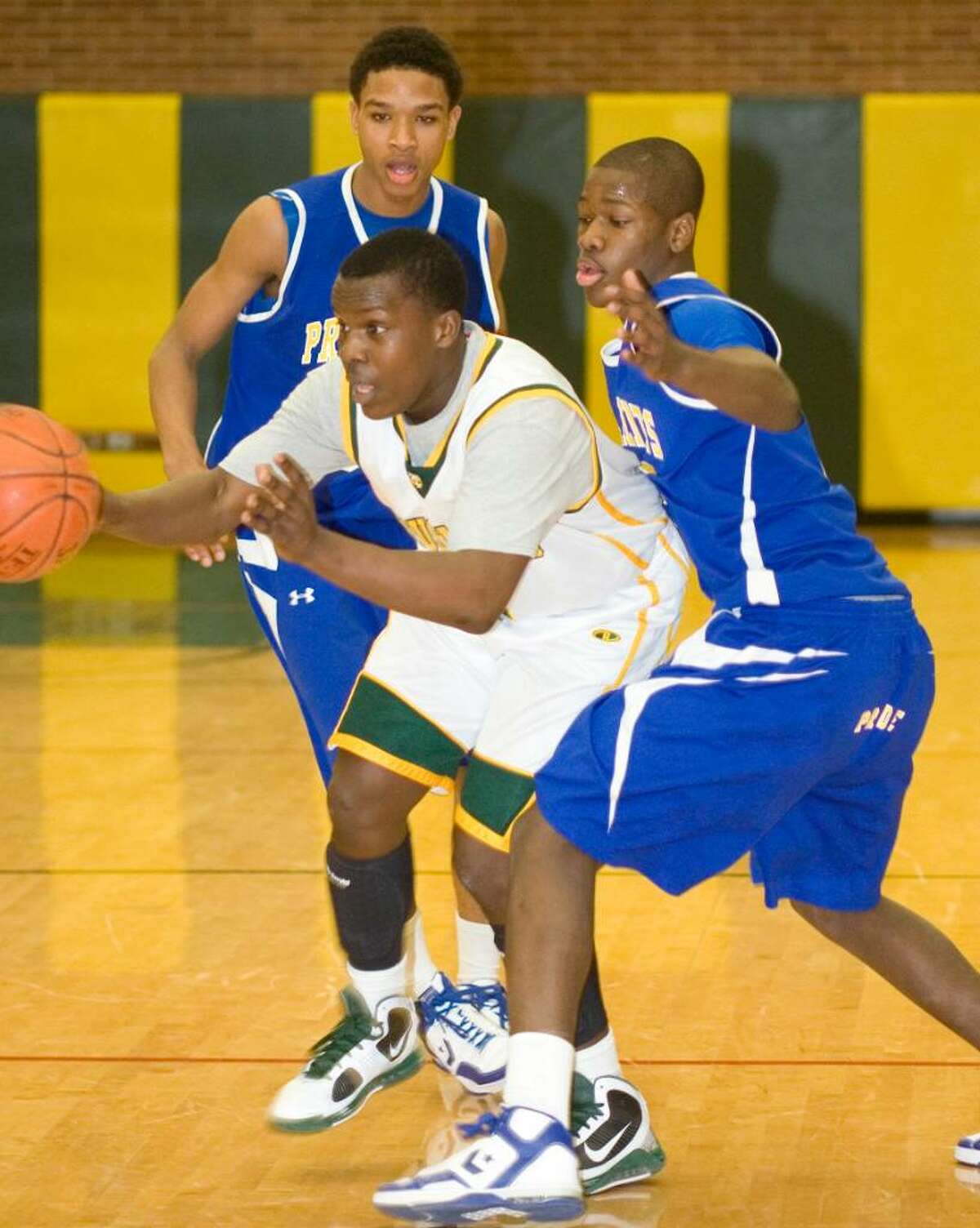 Trinity Catholic High School's #2 Phil Thompson, center, is defended by Harding High School's Corey Baldwin, left, and Kintwan Miles, right, during a boys basketball game in Stamford, CT on Jan. 29, 2010. 2