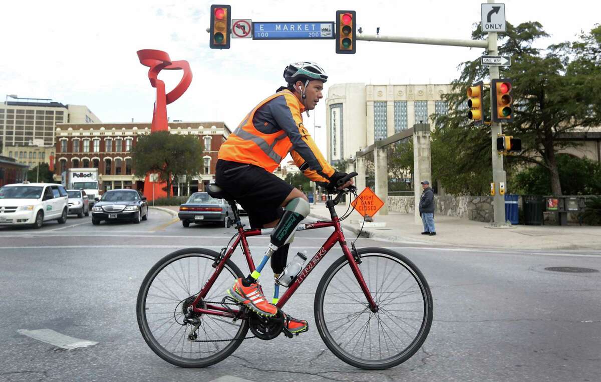 Carlos Gutierrez, whose feet were cut off two years ago by members of a Mexican cartel, pedals from his new home, El Paso to Austin to raise awareness about Mexican corruption. Nov. 7, 2013. He passed by the Torch of Friendship sculpture in downtown San Antonio.