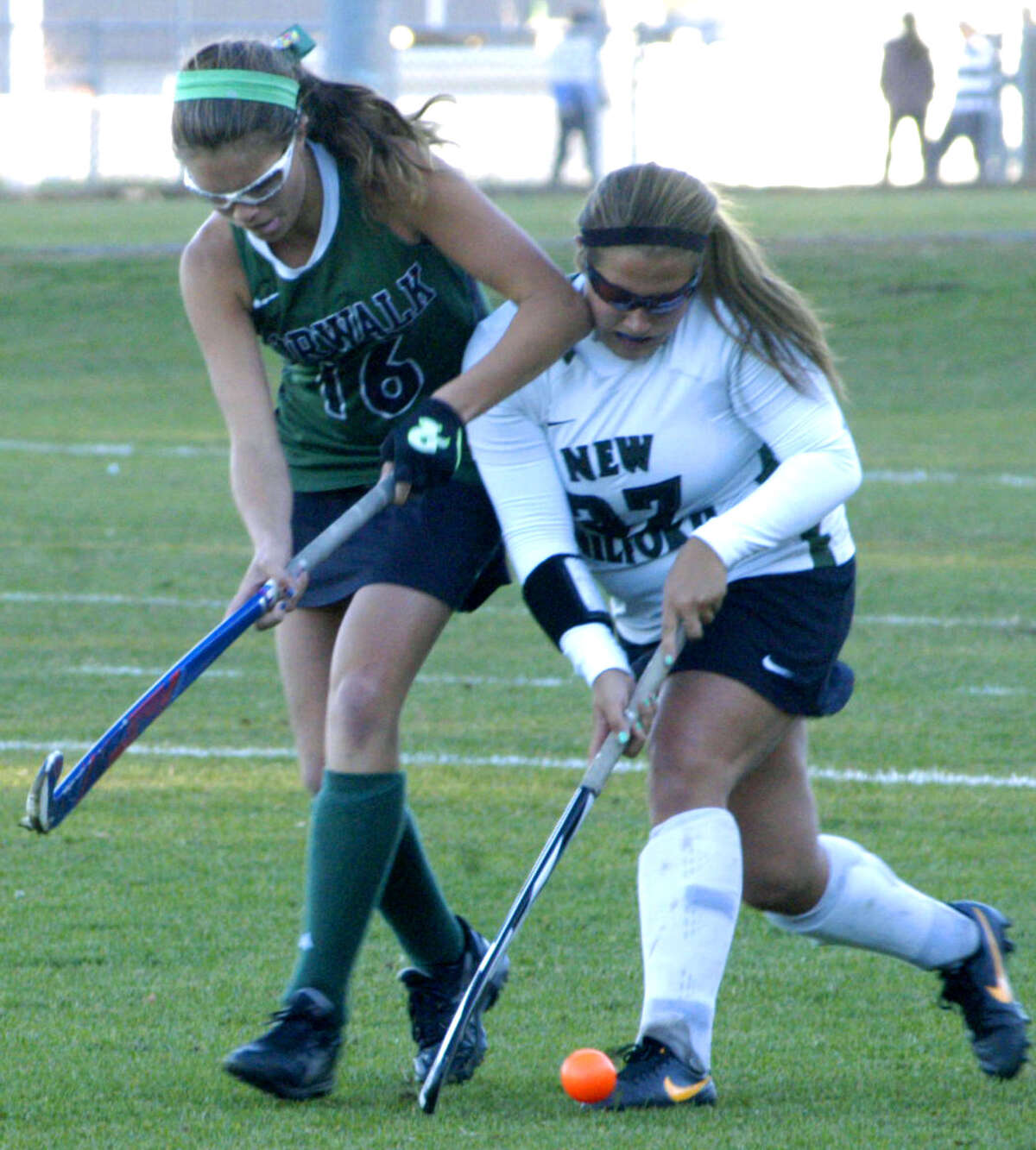 The Green Wave's Lindsey Heaton shrugs off a shot to the face to maintain possession during New Milford High School field hockey's 1-0 victory over Norwalk in the playdown round of the state class 'L' tournament at NMHS. Nov. 4, 2013