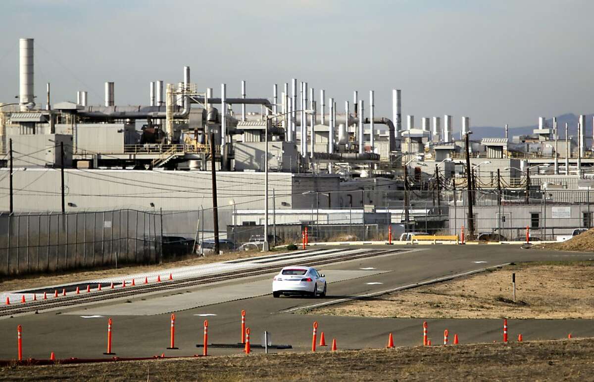 A Tesla all electric car behind the main production plant in Fremont, Ca., on Wednesday Nov. 13, 2013. Three employees were burned Wednesday in an industrial accident at the Tesla Motors plant in Fremont. The three were hurt while working with pressurized equipment, there was no fire or explosion at the plant.