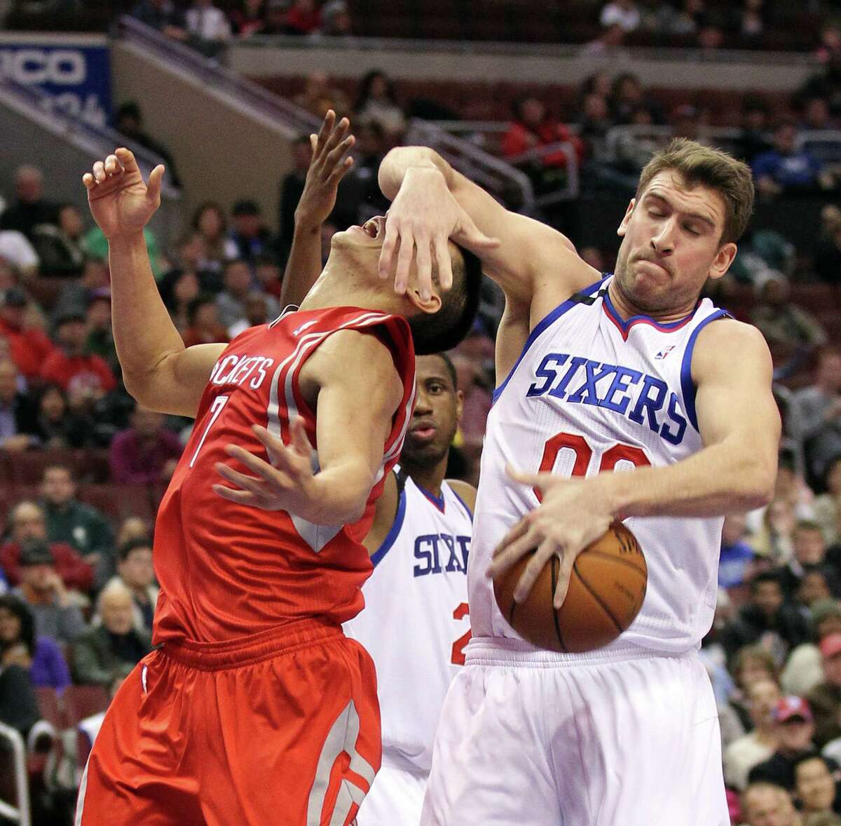 Jeremy Lin, left, gets the short end of the stick from the 76ers' Spencer Hawes in the fourth quarter. The Rockets guard still managed 34 points and 12 assists.