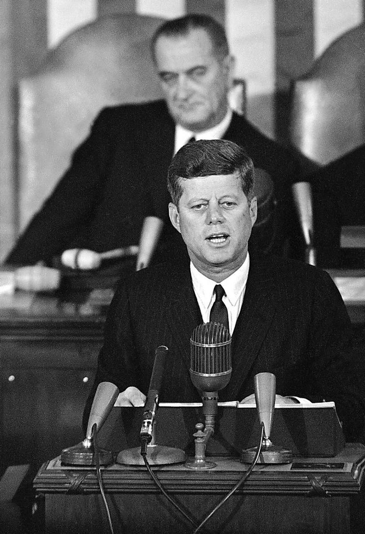 FILE - In this Jan. 14, 1963 file photo, President John F. Kennedy speaks in the House Chamber on Capitol Hill in Washington during his State of the Union report to a joint session of Congress with Vice President Lyndon Johnson sitting behind him. Kennedy's civil rights legacy has undergone substantial reassessment since his Nov. 22, 1963, assassination. His successor, President Johnson, receives credit for hammering through the monumental Civil Rights Act and Voting Rights Act, which ensured full citizenship for African-Americans. (AP Photo/File)